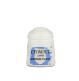 A small white Citadel paint pot is shown upright against a plain background, with a ribbed white lid and a blue-and-white label. The label reads “CITADEL,” “LAYER,” and “DEEPKIN FLESH.”
