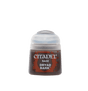 A small Citadel paint pot shown upright, with a translucent pale gray flip-top cap and a dark brown and rust-red label. The label reads “CITADEL,” “BASE,” and “DRYAD BARK.”