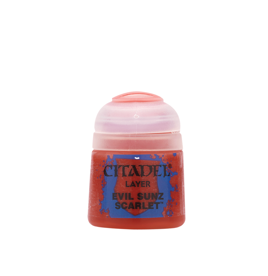 Small red Citadel paint pot shown upright against a plain dark green background, with a pale pinkish-white flip-top lid and a blue-and-red label reading “CITADEL,” “LAYER,” and “EVIL SUNZ SCARLET.”