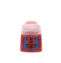 Small red Citadel paint pot shown upright against a plain dark green background, with a pale pinkish-white flip-top lid and a blue-and-red label reading “CITADEL,” “LAYER,” and “EVIL SUNZ SCARLET.”