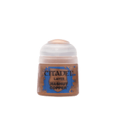 Front view of a small Citadel paint pot with a white cap and copper-brown contents visible through the lower container. Its blue-and-copper label reads “CITADEL,” “LAYER,” and “HASHUT COPPER.”