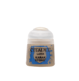 A small paint pot with a white flip-top lid and beige paint visible through the lower container. Its blue-and-tan label reads “CITADEL,” “LAYER,” and “KARAK STONE.”