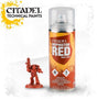 A Mephiston Red spray can with a clear cap and orange-yellow label stands beside a small red-painted armored miniature holding a raised weapon. The can reads “CITADEL MEPHISTON RED” and “MODEL PAINT”; “CITADEL TECHNICAL PAINTS” appears at upper left.