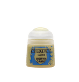 A small squat paint pot with a rounded white flip-top lid and a tan label with blue splashes. The label reads “CITADEL,” “LAYER,” and “OGRYN CAMO.”