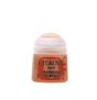 A small pot of peachy tan miniature paint with a pale translucent flip-top lid and orange-red label. The label reads “CITADEL,” “BASE,” and “RATSKIN FLESH.”