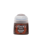 A squat Citadel paint pot with a pale gray cap and a dark brown label accented in red. The label reads “CITADEL,” “BASE,” and “RHINOX HIDE.”