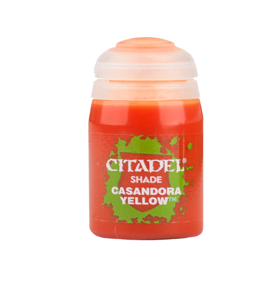 Front view of a small orange-red Citadel paint pot with a white stepped cap and a green splatter graphic on its label. The label reads “CITADEL,” “SHADE,” and “CASANDORA YELLOW.”