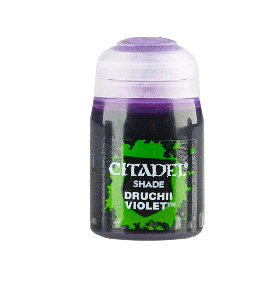 A small paint pot stands upright against a plain background, with a translucent white cap and a dark body bearing a bright green splatter label. The label reads “CITADEL,” “SHADE,” and “DRUCHII VIOLET.”