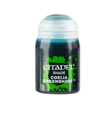 A small Citadel shade paint pot stands upright with a white cap and a dark label splashed with bright green. The label reads “CITADEL,” “SHADE,” and “COELIA GREENSHADE.”