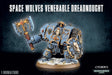 Blue-gray Space Wolves Venerable Dreadnought miniature with gold trim, holding a large axe and round shield, stands on a snowy base. The heading reads “SPACE WOLVES VENERABLE DREADNOUGHT,” with “1 MINIATURE” at lower left.
