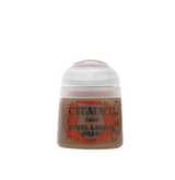 A small Citadel paint pot stands upright, with a white rounded flip-top lid and a brown-toned body. Its orange-red splatter label reads “CITADEL,” “BASE” and “STEEL LEGION DRAB.”