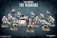 A squad of white-armored T’au Fire Warriors with red accents and rifles stands on round bases among a support turret and hovering drones against a dark blue textured background. The text reads “TAU EMPIRE FIRE WARRIORS” and “13 MINIATURES.”