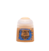 A small ochre-colored paint pot with a rounded white flip-top cap, shown upright against a plain background. Its blue-and-brown label reads “CITADEL,” “LAYER,” and “TAU LIGHT OCHRE.”