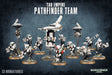 Promotional image of the Tau Empire Pathfinder Team, showing multiple white-and-black sci-fi soldier miniatures with red accents on round bases, alongside hovering drones, against a dark blue background. Text reads “TAU EMPIRE PATHFINDER TEAM” and “13 MINIATURES,” with a Warhammer 40,000 logo.