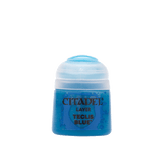 A small blue Citadel paint pot with a translucent white flip-top lid, shown upright against a plain background. Its label reads “CITADEL,” “LAYER,” and “TECLIS BLUE.”
