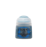 A small, squat paint pot with a translucent pale blue flip-top lid and a blue label with mottled blue-gray graphics. The label reads “CITADEL,” “LAYER,” and “THUNDERHAWK BLUE.”