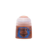 A small pot of rusty brown Citadel layer paint with a pale translucent screw-top lid. The blue front label reads “CITADEL,” “LAYER,” and “TUSKGOR FUR.”