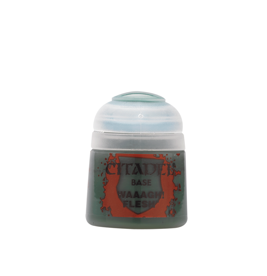 A small Citadel paint pot stands against a plain green background, with a rounded white cap and a dark green body. Its orange-red label reads “CITADEL,” “BASE,” and “WAAAGH! FLESH.”