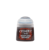 A small Citadel paint pot with a pale gray flip-top lid and a dark brown label with red accents. The label reads “CITADEL,” “BASE,” and “WARPLOCK BRONZE.”