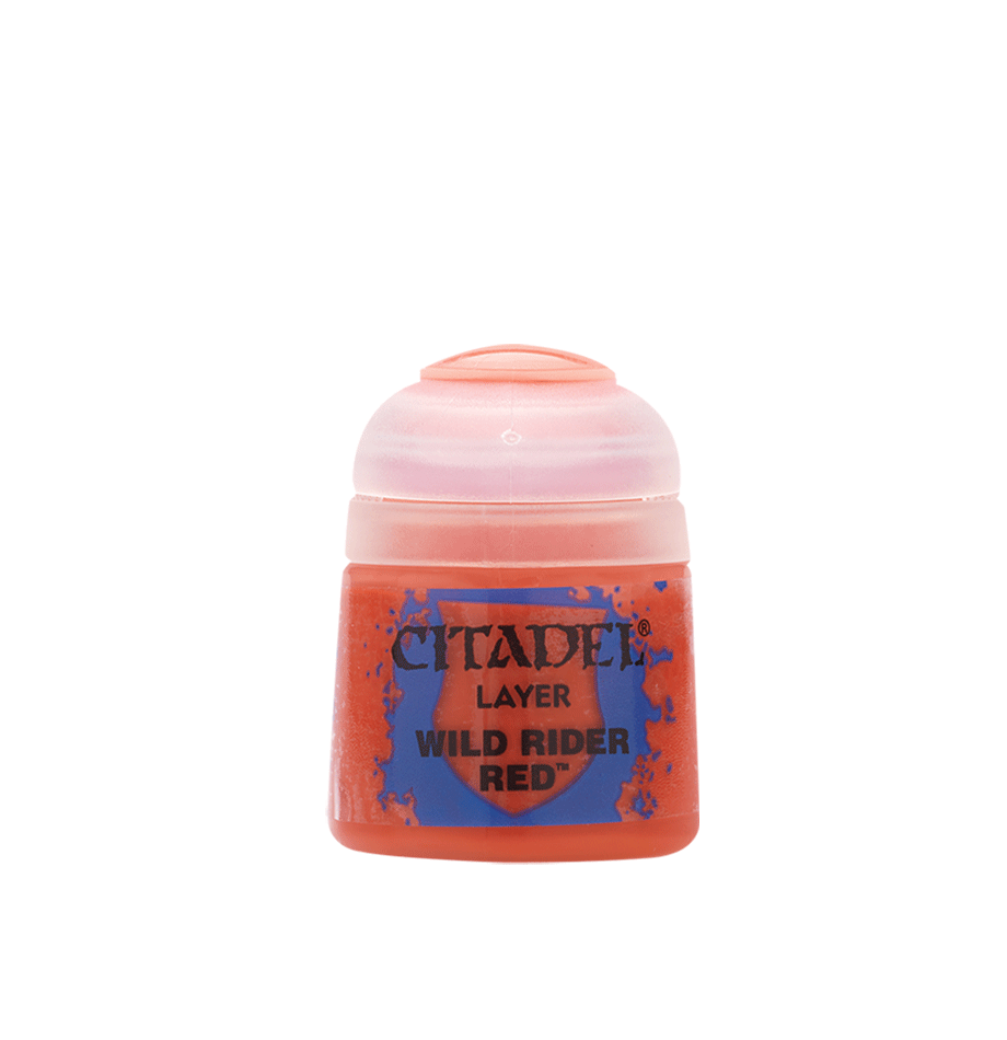 A small squat pot of red miniature paint stands alone against a plain background, with a translucent pale pink cap and a blue-and-red splatter label reading “CITADEL,” “LAYER,” and “WILD RIDER RED.”