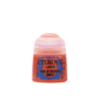 A small squat pot of red miniature paint stands alone against a plain background, with a translucent pale pink cap and a blue-and-red splatter label reading “CITADEL,” “LAYER,” and “WILD RIDER RED.”
