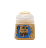A small ochre-colored Citadel paint pot with a rounded white cap, shown upright against a plain light background. Its blue-and-tan label reads “CITADEL,” “LAYER,” and “ZAMESI DESERT.”
