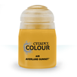 A squat golden-yellow paint bottle stands upright against a white background, with a large translucent off-white cap. The front label reads “CITADEL COLOUR,” “AIR,” and “AVERLAND SUNSET.”