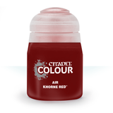 A squat dark red paint bottle stands upright against a white background, with a pale translucent cap and label text reading “CITADEL COLOUR,” “AIR,” and “KHORNE RED.”