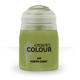 A squat olive-green paint bottle stands upright with a pale gray-white cap. Its label reads “CITADEL COLOUR,” “AIR,” and “OGRYN CAMO.”