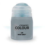 Front-facing squat paint bottle in muted blue-gray with a large rounded pale cap, shown against a white background. The black label reads “CITADEL COLOUR,” “AIR,” and “RUSS GREY.”