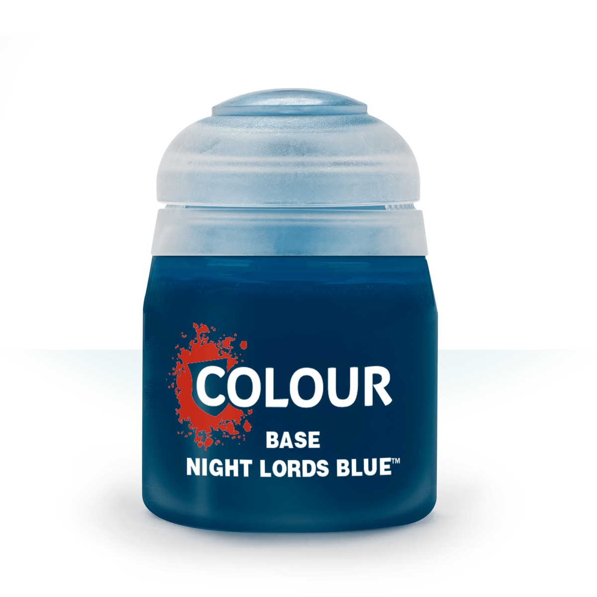 A squat, dark blue paint pot with a pale blue-gray domed lid is shown upright against a white background. Its label has a red paint-splatter graphic and the white text “COLOUR,” “BASE,” and “NIGHT LORDS BLUE.”