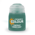 A squat dark green paint bottle with a pale gray ridged cap stands upright against a white background. Its front label has an orange splatter graphic and the text “CITADEL,” “COLOUR,” and “CONTRAST,” with “CREED CAMO” below.