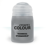 A squat, translucent gray paint pot with a wide white flip-top lid is shown upright against a white background. Its front label reads “CITADEL COLOUR” and “TECHNICAL STORMSHIELD.”