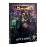 Hardback Necromunda book shown upright, with cover art of three armed women in detailed sci-fi outfits against a dark industrial background. The cover reads “NECROMUNDA” and “HOUSE OF BLADES.”