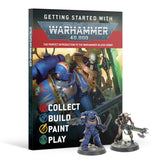 Warhammer 40,000 introductory magazine standing upright, with cover art of armored sci-fi warriors and the words “GETTING STARTED WITH” and “WARHAMMER 40,000.” A blue-armored figure and a skeletal-looking figure holding a long weapon stand in front; “COLLECT BUILD PAINT PLAY” appears on the cover.