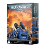 Box for the Space Marines Hammerfall Bunker miniature, showing a blue armored bunker with twin heavy weapons and small blue-armored figures against a fiery battlefield. The front reads “WARHAMMER 40,000” and “SPACE MARINES HAMMERFALL BUNKER”; a narrow side panel shows another bunker view.