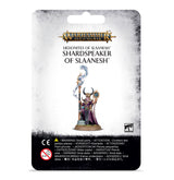 Front of a hanging Warhammer miniature package with a white and gray card and black warning panel. The artwork shows a horned figure in purple robes holding a staff and an ornate object; text reads “WARHAMMER AGE OF SIGMAR” and “SHARDSPEAKER OF SLAANESH.”