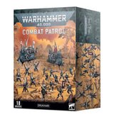 Drukhari Combat Patrol miniature set in a tall box, shown from the front and right side. The front depicts dark armored figures and vehicles in an orange desert scene beneath “WARHAMMER 40,000” and “COMBAT PATROL,” with “18 MINIATURES” and “DRUKHARI” at the bottom; the side shows more figures.