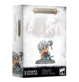 Box for a Gardus Steel Soul miniature, with white and gray artwork and a small armored figure in gold, silver and blue holding a hammer on a round base. The box reads “WARHAMMER AGE OF SIGMAR” and “1 CITADEL MINIATURE.”