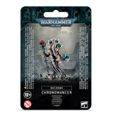 Front of a black Warhammer 40,000 package showing a skeletal sci-fi Necrons Chronomancer miniature with a staff, teal and pink accents, and trailing cables. The package reads “WARHAMMER 40,000” and “NECRONS CHRONOMANCER.”