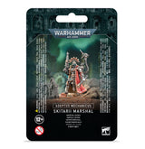 Black hanging-card packaging for a Warhammer 40,000 miniature, with artwork of an armored, hooded Skitarii figure carrying weapons and wearing a red cape. The package reads “ADEPTUS MECHANICUS” and “SKITARII MARSHAL,” with a 12+ age mark.