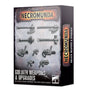 Box for Necromunda Goliath Weapons & Upgrades, shown from the front and right side. The weathered gray front displays rows of dark metallic weapon components on a grid, with orange-and-black “NECROMUNDA” lettering and white “GOLIATH WEAPONS & UPGRADES” text; the side repeats the title.