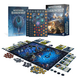 Warhammer Underworlds: Harrowdeep game set displayed with a blue illustrated box, a matching rulebook, token sheet, cards, dice, miniatures and a blue hex-grid board. The box and book read “WARHAMMER UNDERWORLDS HARROWDEEP”; the book also reads “RULEBOOK”.