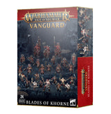 Box for a Warhammer Age of Sigmar miniatures set, shown from the front and right side. The front depicts armored warriors and mounted fighters in a dark rocky scene; red-and-gold trim frames the text “VANGUARD” and “BLADES OF KHORNE,” with “24 MINIATURES” at the bottom.