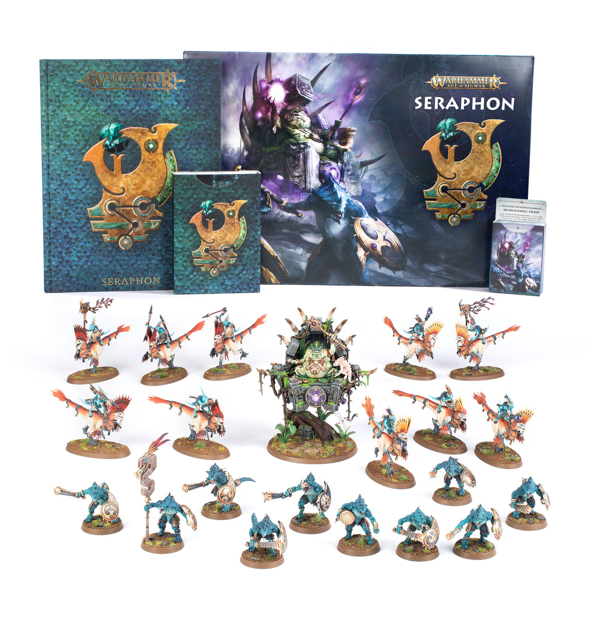Seraphon army set displayed with rows of turquoise-and-orange reptilian warrior miniatures on round bases and a larger seated figure on an ornate throne. Illustrated boxes and books stand behind them, with “SERAPHON” and “WARHAMMER” visible.