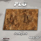 Rectangular gaming mat shown flat, printed with a mottled rusty-brown junkyard surface, scattered debris and small metal grates. The graphic reads “FLG MATS,” “Junkyard” and “44x30”,” with a Frontline Gaming logo below.