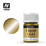 A metallic green-gold paint bottle with a white ribbed cap stands beside a round gold-toned color swatch. The label reads “Liquid Gold,” “Oro Líquido,” and “Oro Verde 795 Green Gold”; the Vallejo logo appears above.