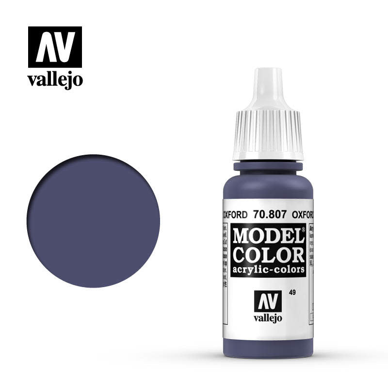 A small dropper bottle of dark Oxford blue paint with a white ribbed cap stands beside a matching circular color swatch. The label reads “MODEL COLOR” and “OXFORD,” with Vallejo branding above.