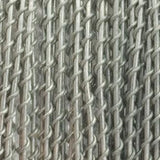 Close-up of gray barbed wire arranged in dense parallel rows, with twisted strands and short sharp barbs crossing between them. No packaging or text is visible.