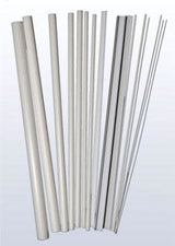 A fan-shaped assortment of long, narrow white and light gray plastic tubes, beams, and rods, arranged upright side by side in varying widths, from thick hollow-looking pieces to very thin strips.